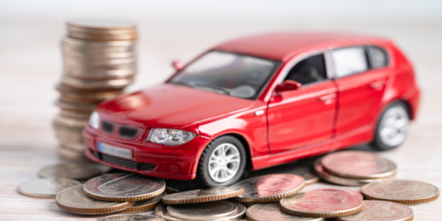 A red car on a pile of coins AI-generated content may be incorrect.