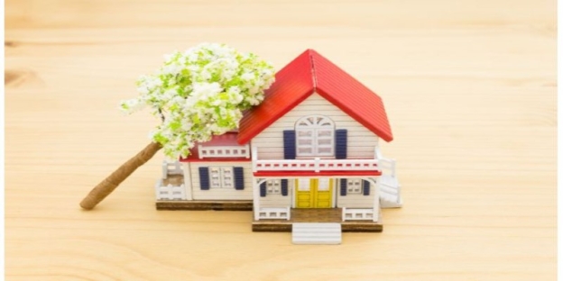 A small model house with a tree on top AI-generated content may be incorrect.