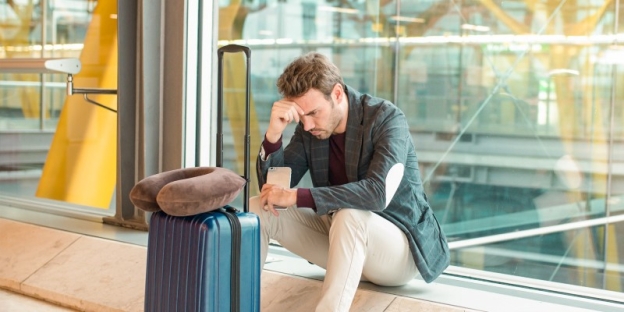 A person sitting on the floor looking at a piece of luggage AI-generated content may be incorrect.